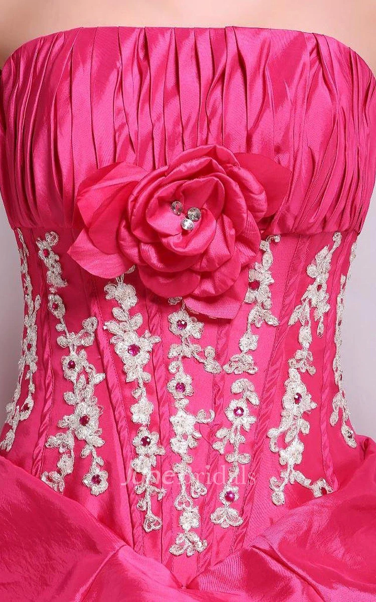 Strapless Ball Gown With Ruffles and Flower Detail
