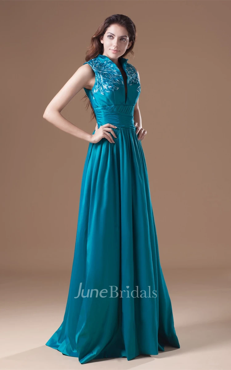 high-neck floor-length sleeveless dress with pleats and embroideries